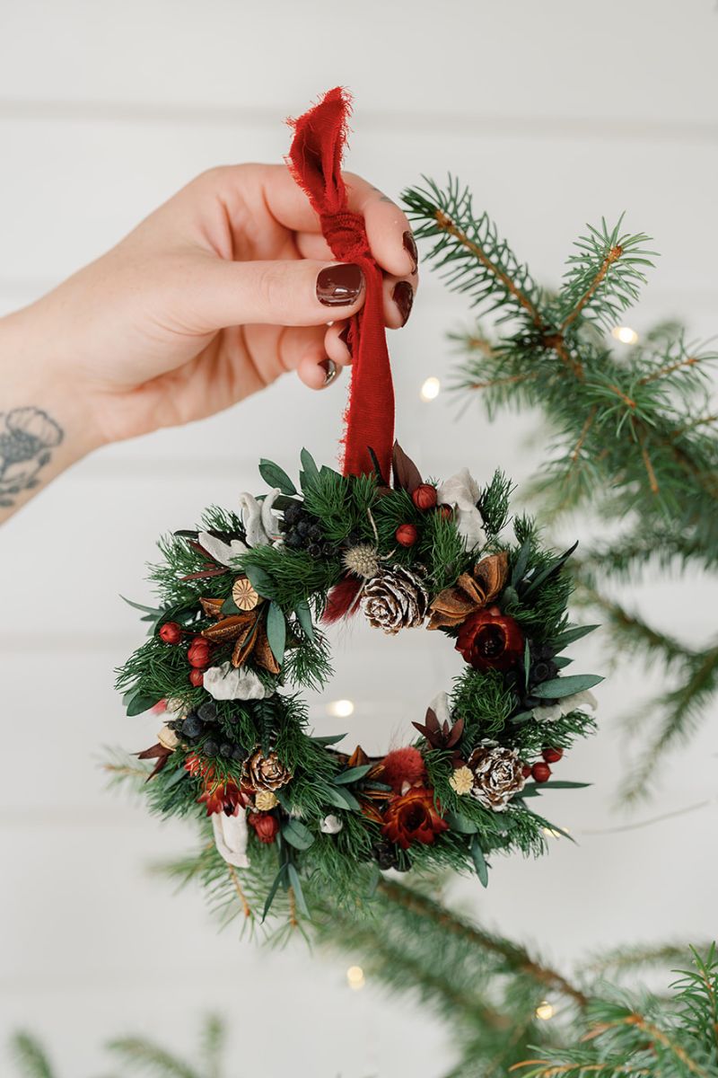 Christmas wreath shaped dried flower bauble in red and greens