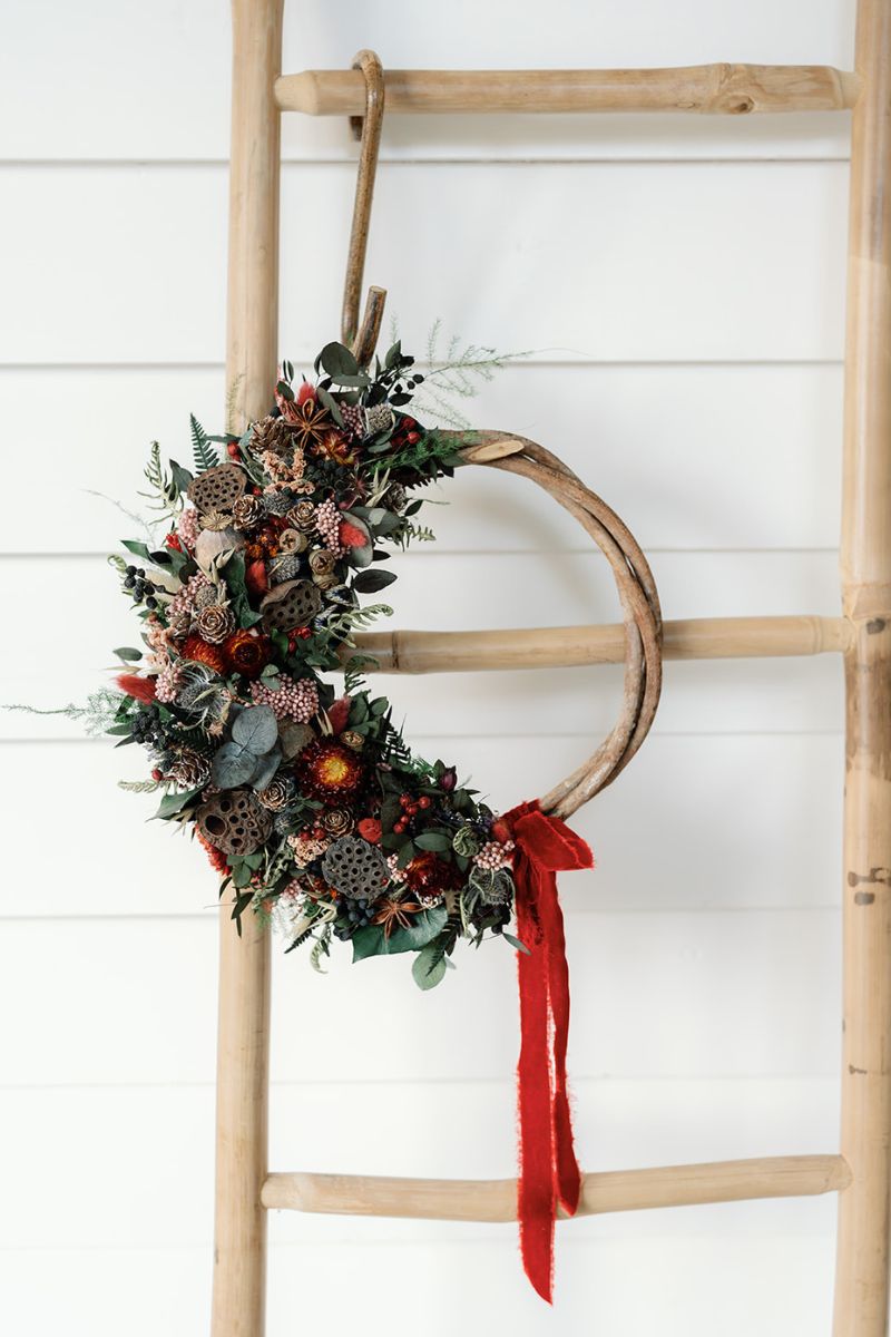 Decorative Dried Flower Christmas wreath with red ribbon.