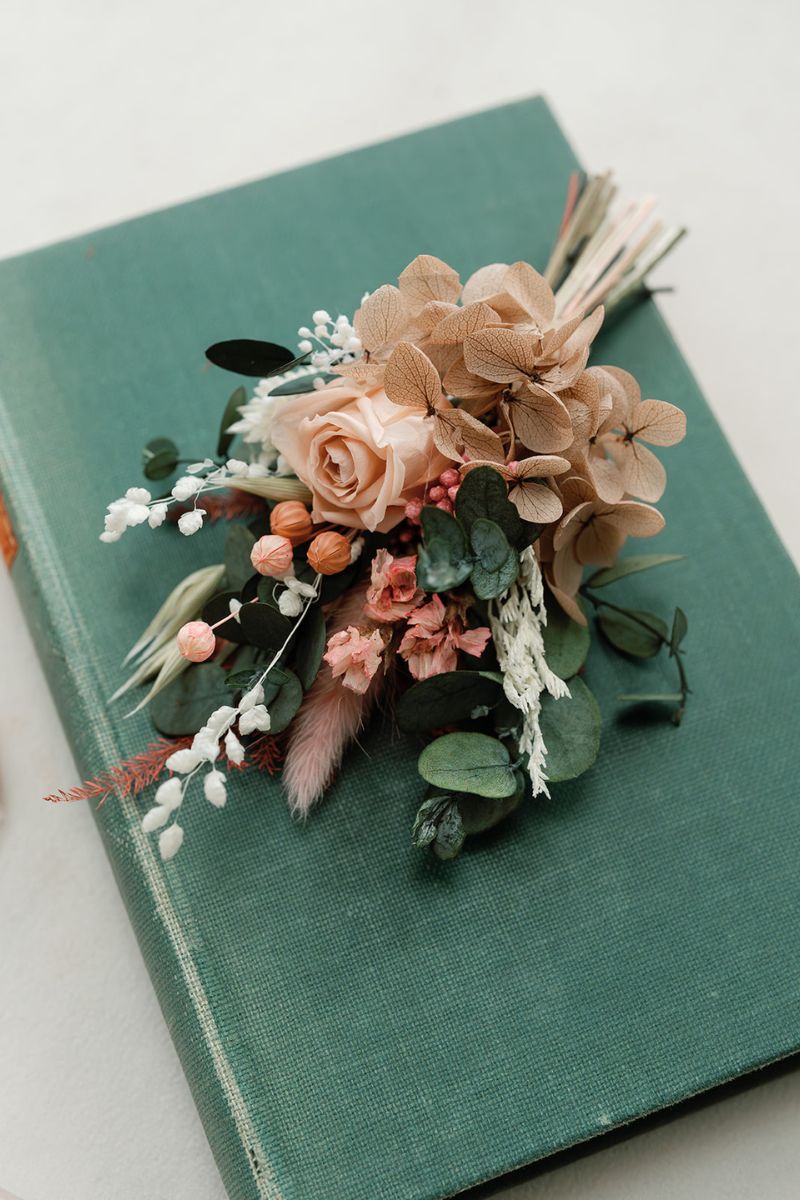 Summer wedding coral pink dried and preserved flower buttonhole for grooms.