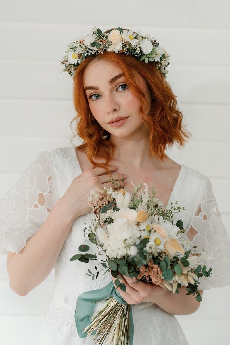 Dried and preserved bridal flower crown in peach, white and sage green tones, tied with a silk ivory ribbon.
