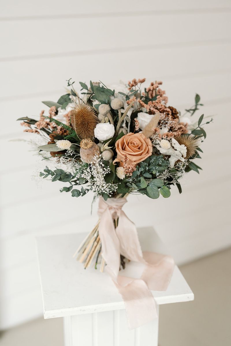 Rustic winter wedding inspired dried and preserved bridal bouquet with nude, white, silver and green tones, hand tied with silk ribbon.