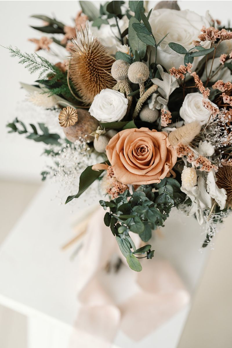 Rustic winter wedding inspired dried and preserved bridal bouquet with nude, white, silver and green tones, hand tied with silk ribbon.