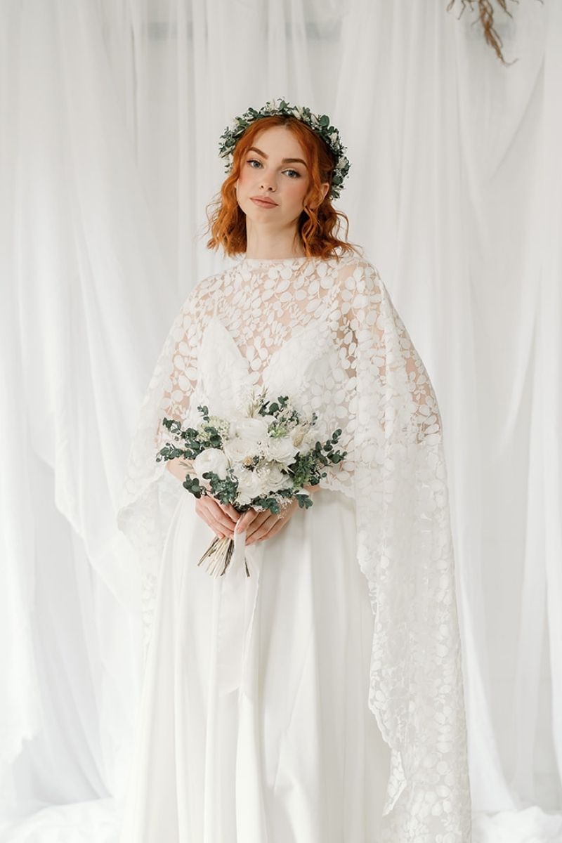 Preserved flower bridal bouquet with white peonies, roses and lime green hydrangea with lush eucalyptus foliage and finished with a silk ribbon around the stems