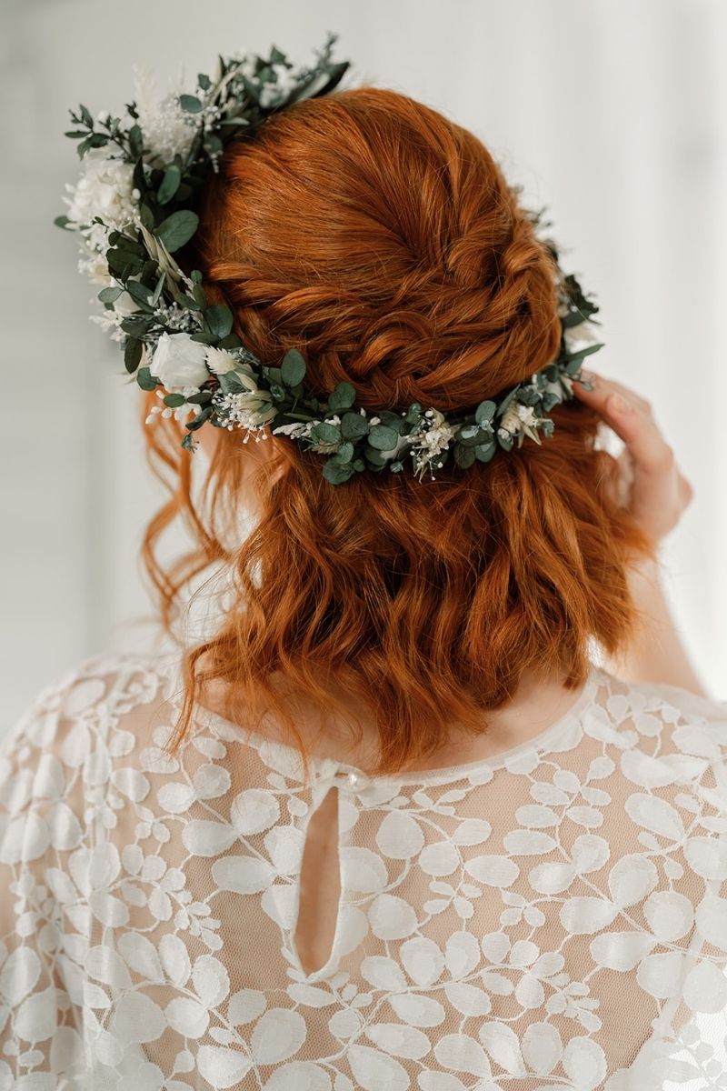 green and white full circular dried flower crown with a focal arrangement of white roses and hydrangea.