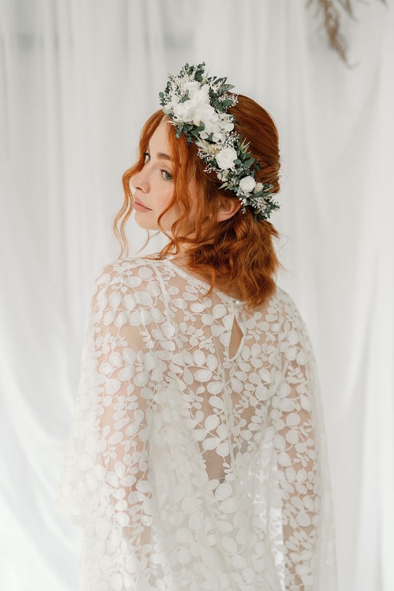 green and white full circular dried flower crown with a focal arrangement of white roses and hydrangea.