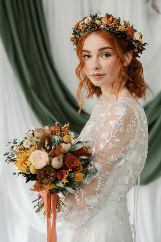 autumnal themed dried flower bridal bouquet in shades of mustard yellow, rust, crowns and lush greenery, hand tied with a rust silk ribbon.