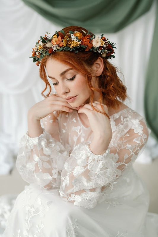 Autumnal dried flower crown with mini peach preserved roses, pine cones, daisies, straw flowers and eucalyptus, a full circular crown.