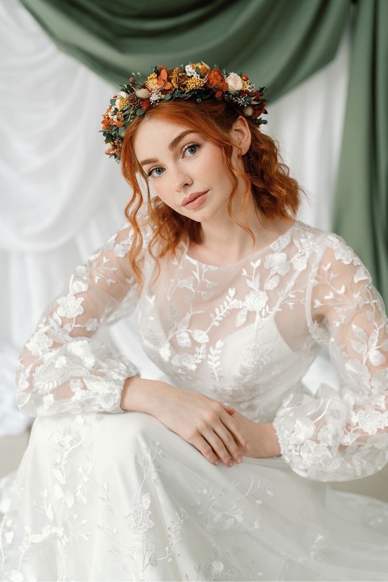 Autumnal dried flower crown with mini peach preserved roses, pine cones, daisies, straw flowers and eucalyptus, a full circular crown.