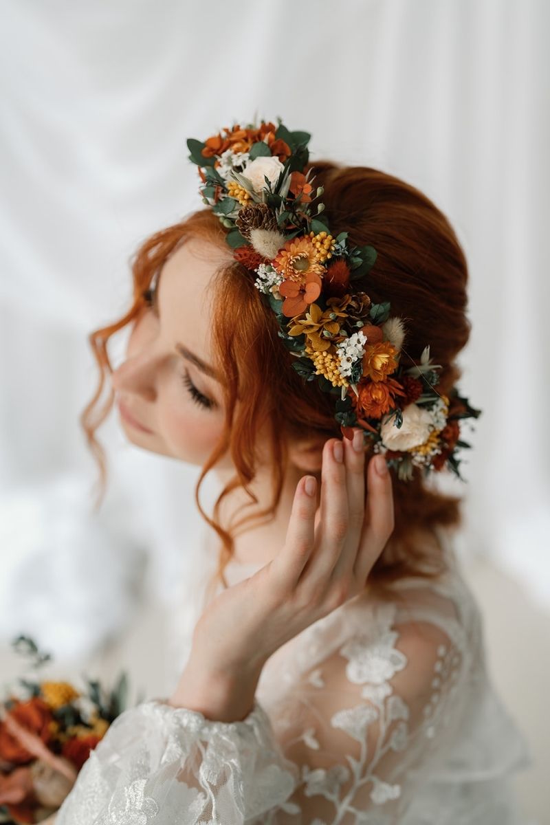 Autumnal dried flower crown with mini peach preserved roses, pine cones, daisies, straw flowers and eucalyptus, a full circular crown.