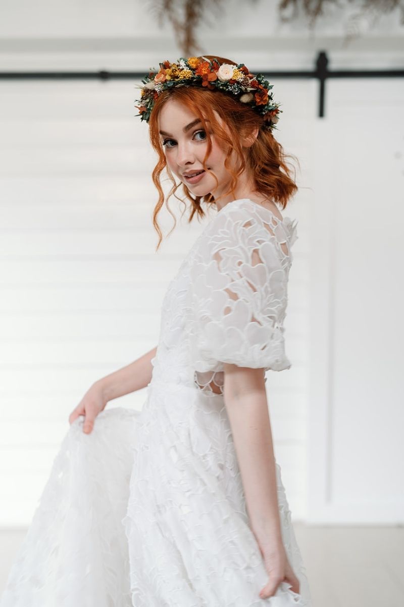 Autumnal dried flower crown with mini peach preserved roses, pine cones, daisies, straw flowers and eucalyptus, a full circular crown.