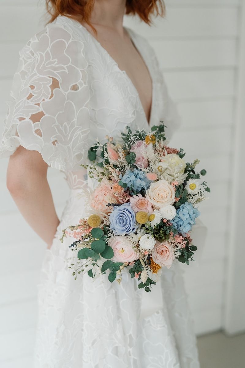 Pastel garden style dried and preserved bridal bouquet with roses, daisies, hydrangeas and eucalyptus