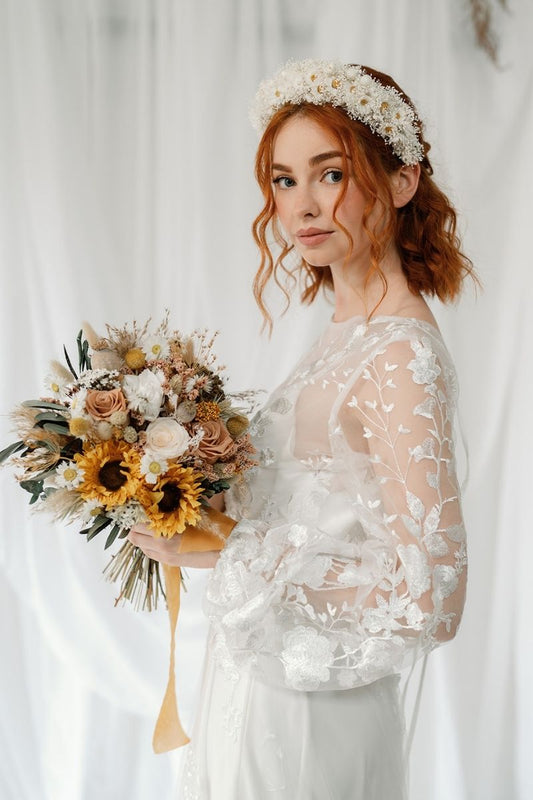 Modern bohemian style dried flower bridal  bouquet with sunflowers mixed with nude, champagne and brown tones, key features being the fluffy pampas grass and lush greenery.