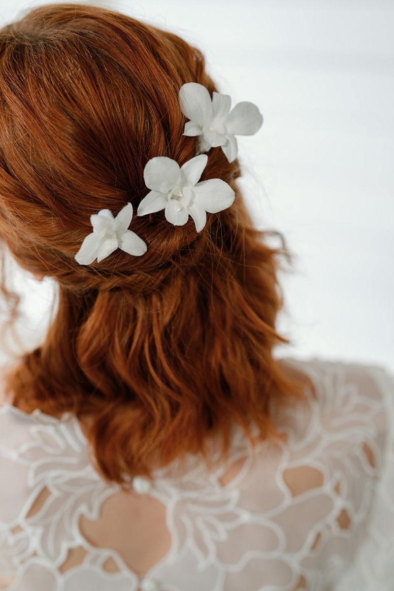 white preserved orchid hair pins perfect for beach weddings by luna and wild