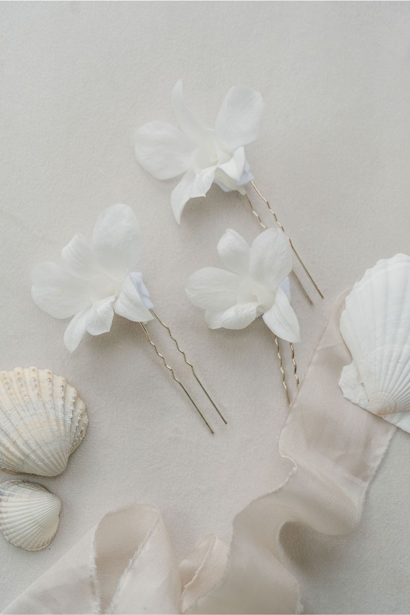 white preserved orchid hair pins perfect for beach weddings by luna and wild
