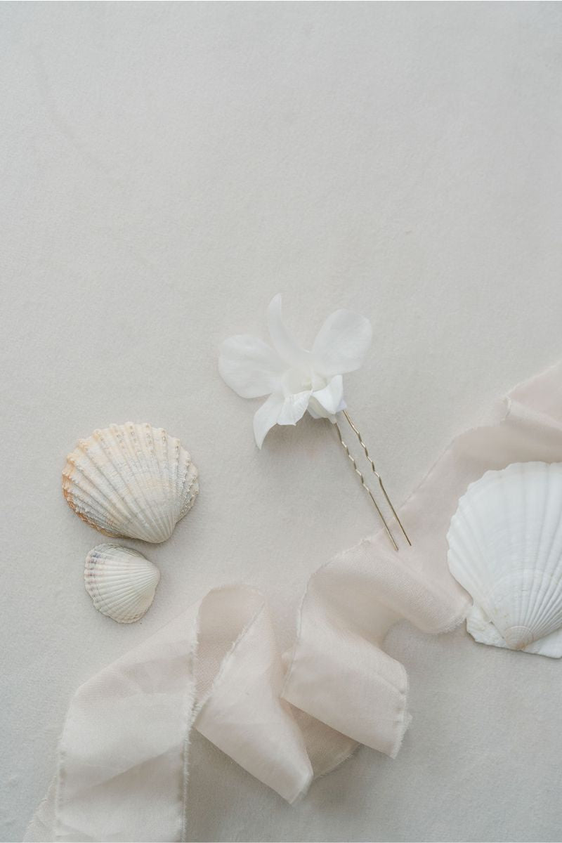 white preserved orchid hair pins perfect for beach weddings by luna and wild