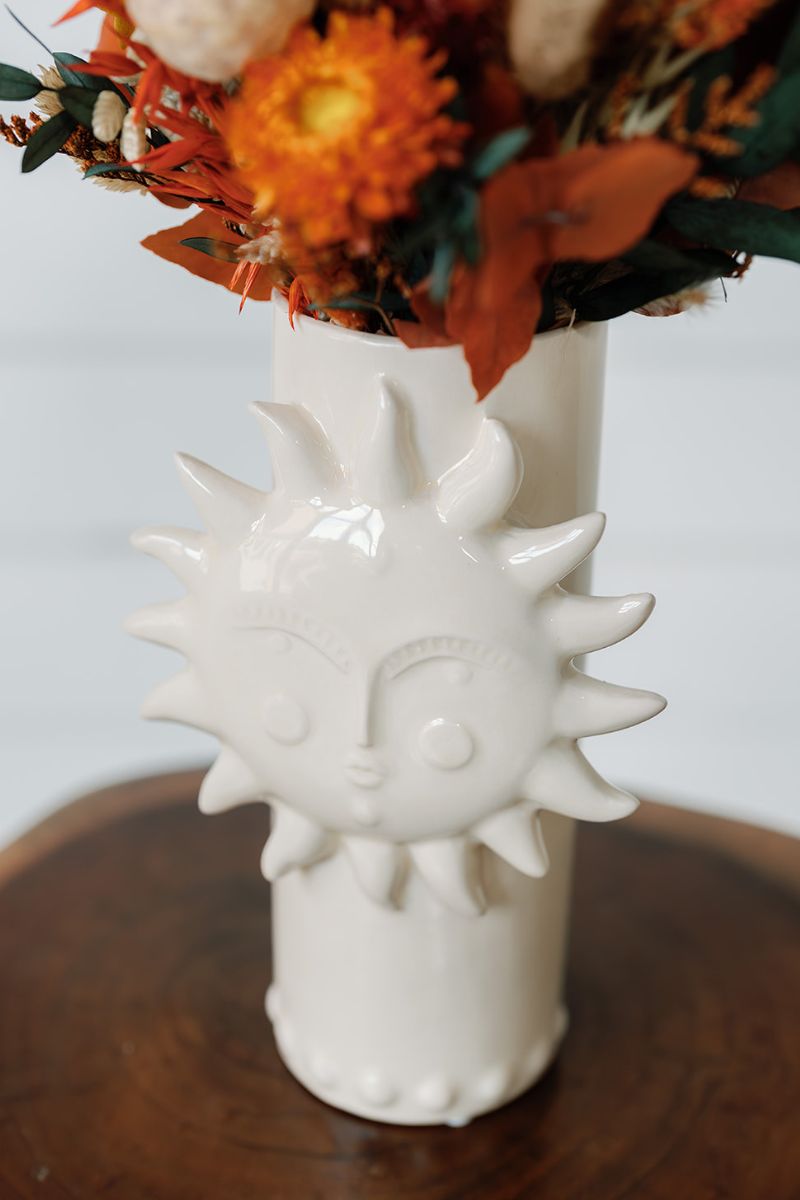 Ivory vase with sun face design 